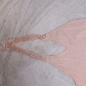 Peach colored backless dress with crochet bottom and top straps